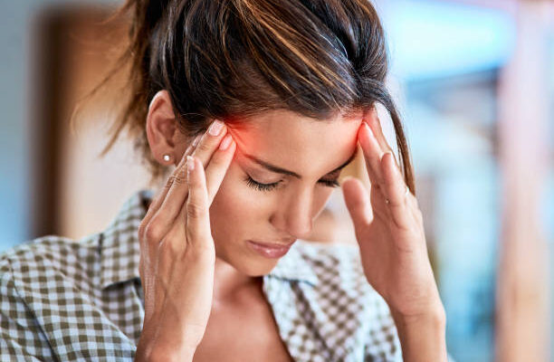 A woman holding her forehead